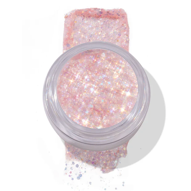 Top view of pink glitter gel in jar with product swiped underneath, sparkling under light.
